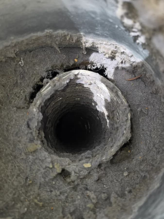 Lint buildup restricting the opening of a dryer vent pathway
