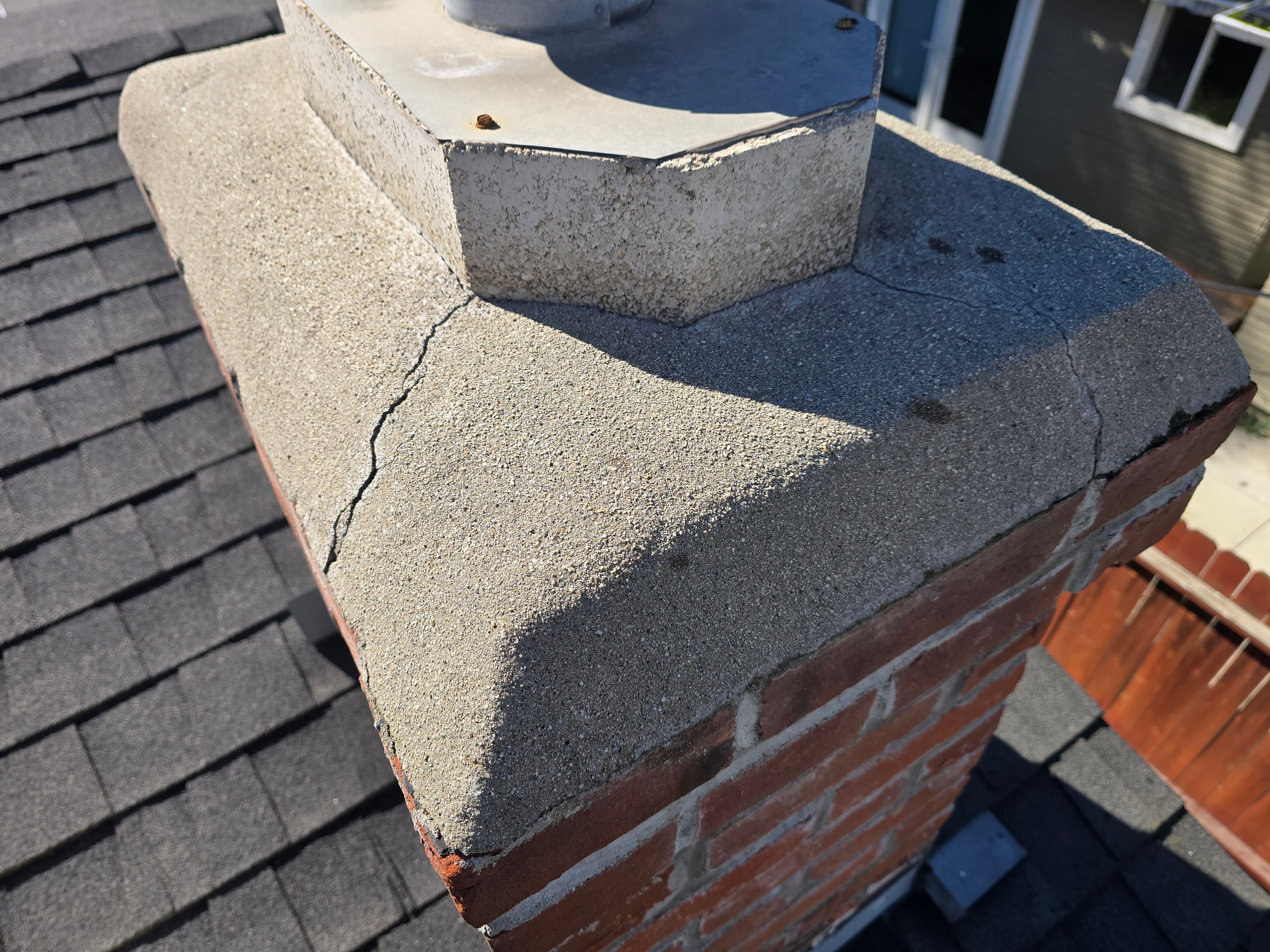 Cracked chimney crown allowing water intrusion risk