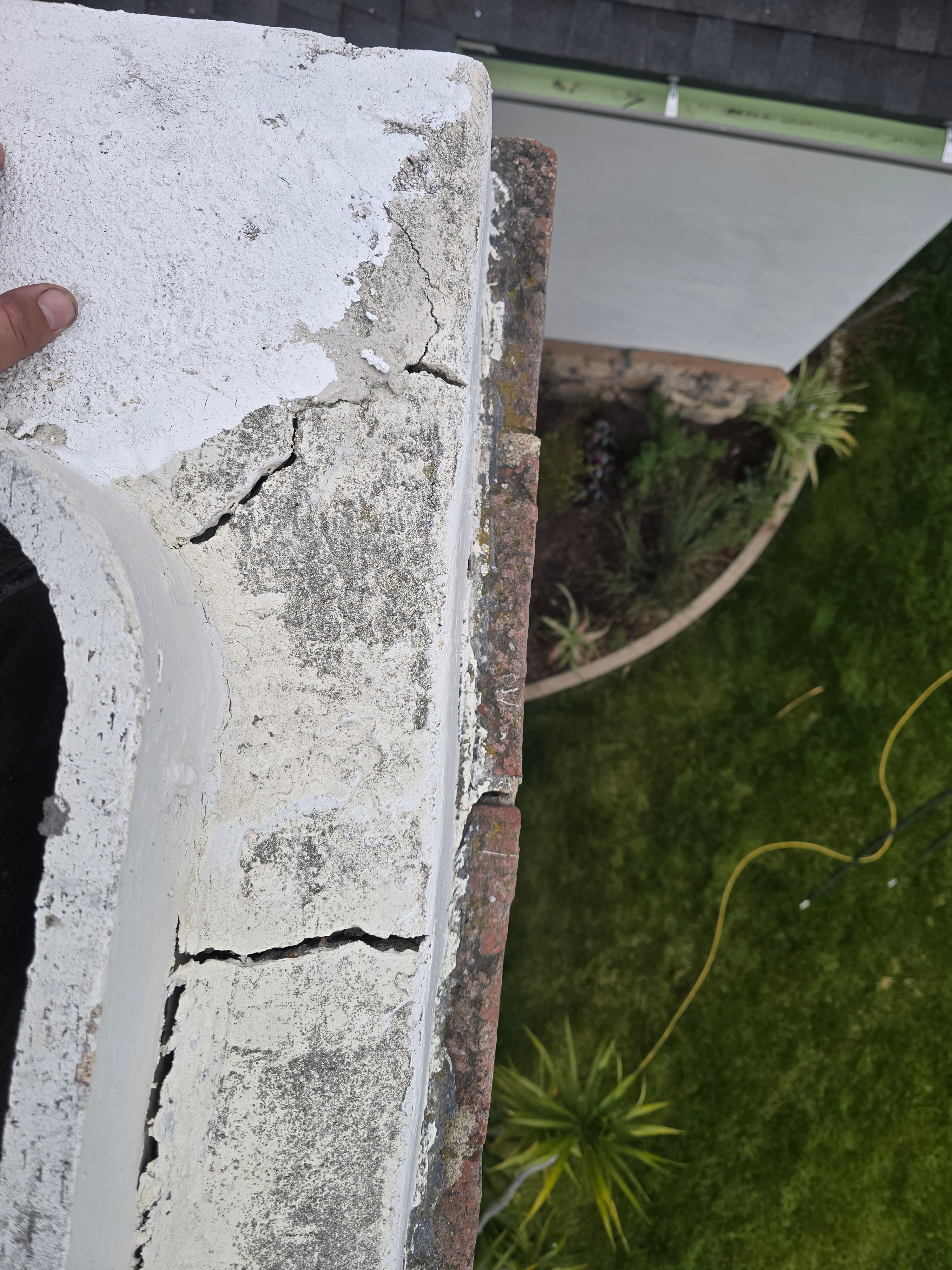 Close-up of cracked masonry chimney crown